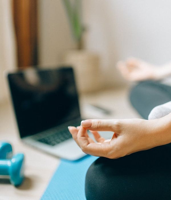 Woman performing a calm cardio exercise in a bright room.